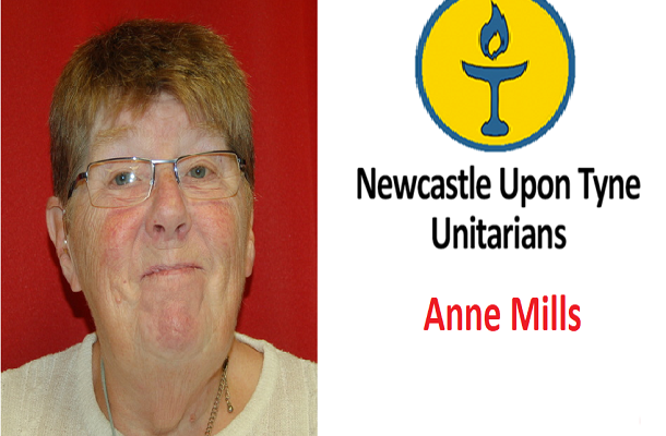 Portrait of Anne Mills, wearing a white top and chalice necklace.