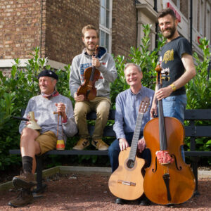 Shunyata Improvisation Group: four people seated together in a hall, holding stringed instruments.