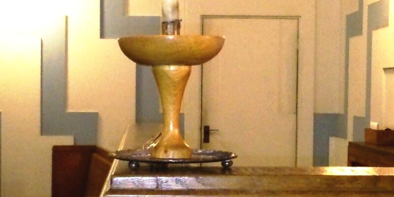 A lit chalice at Newcastle upon Tyne Unitarians