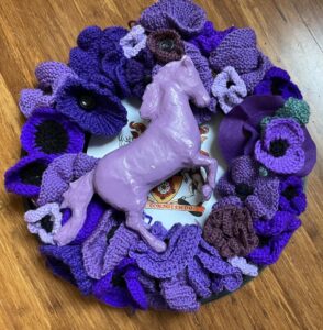 A purple poppy wreath remembering animals who served in times of war.